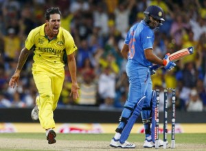 Australian bowler Mitchell Johnson (L) reacts after bowling out India's Rohit Sharma (R) during their Cricket World Cup semi-final match in Sydney