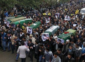 Men carry coffins for the seven people who were killed by unknown militants, heading towards the presidential palace, during a protest procession in Kabul, Afghanistan
