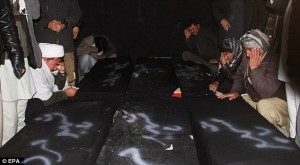2E465A1E00000578-3314792-Relatives_weep_beside_the_coffins_of_Afghan_civilians_from_the_H-a-52_1447299017191