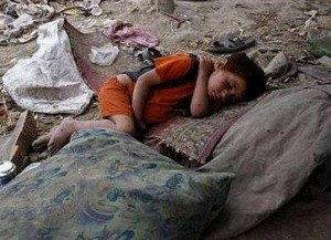 AFG_homeless_boy_sleeps_at_a_waste_disposal_site