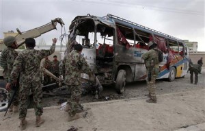 Members of the Afghan national army remove a bus destroyed from the site of a suicide attack in Kabul
