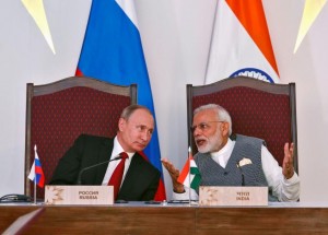 India's Prime Minister Narendra Modi speaks with Russian President Vladimir Putin during exchange of agreements event after India-Russia Annual Summit in Benaulim, in the western state of Goa
