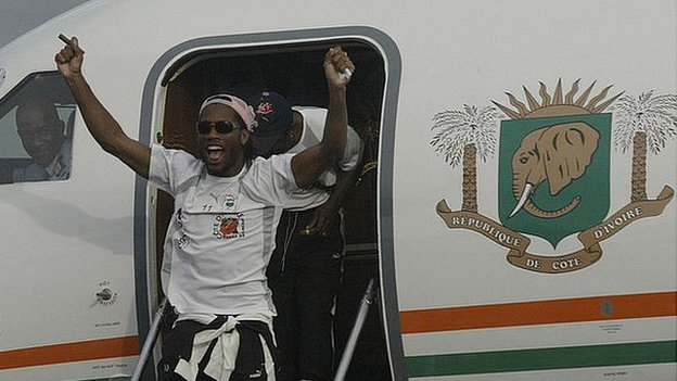 Didier Drogba emerges from the plane that took the victorious Ivory Coast team back home from Sudan